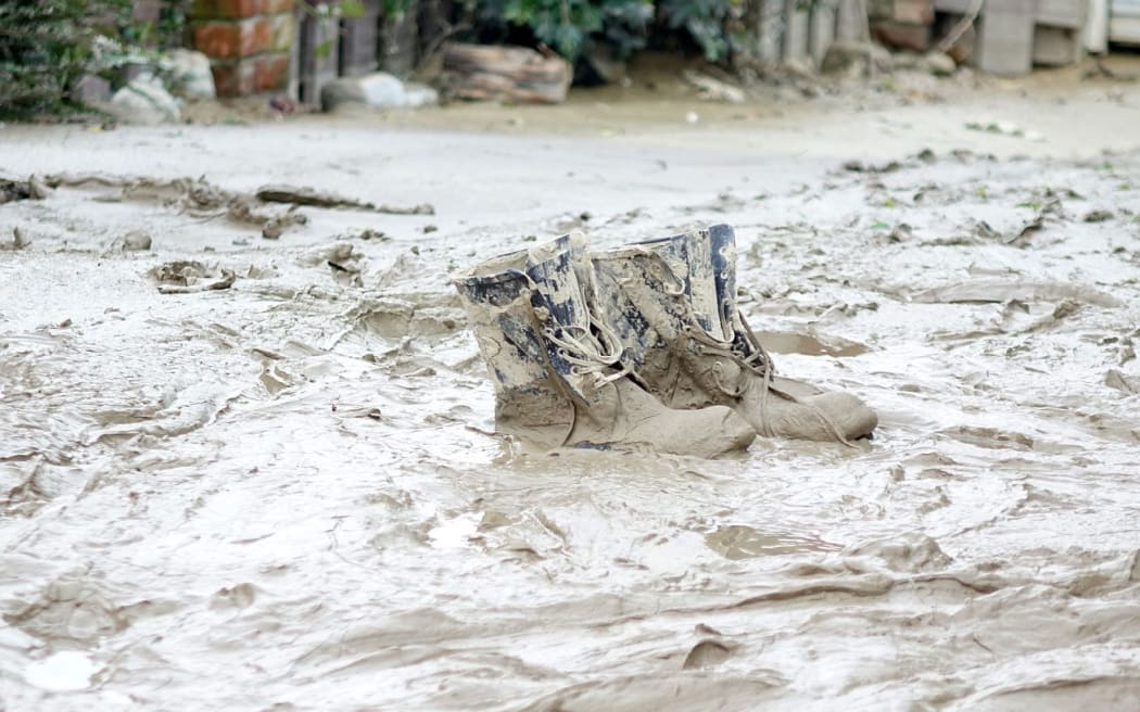 muddy boots surounded by floodwaters