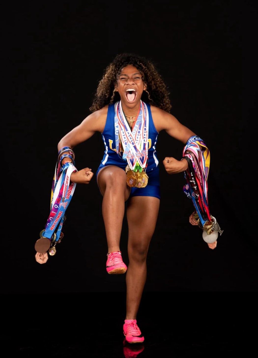 Laiana McClinton with medals she has won over her young career.