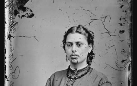 Head and shoulders studio portrait of a Maori woman with moko. c1871.
