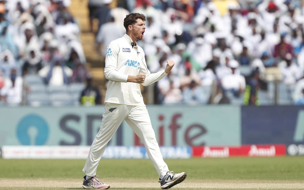 Mitchell Santner of New Zealand celebrates a wicket, India, 2024.