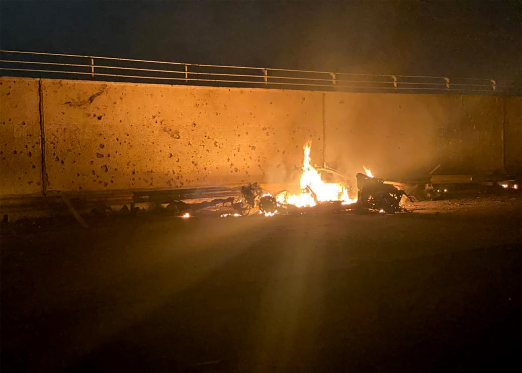 A picture published by the media office of the Iraqi military's joint operations forces on their official Facebook page shows a destroyed vehicle on fire following a US strike on January 3, 2020 on Baghdad international airport road.