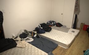 Mattresses lie on the floor of a room in a three-bedroom house in Papakura, Auckland, that is being used by more than 30 migrant workers.