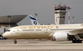 A closeup picture taken on February 20, 2022 shows an Etihad Airways Boeing 787 landing at Israel's Ben Gurion International airport in Lod, on the outskirts of Tel Aviv. (Photo by JACK GUEZ / AFP)