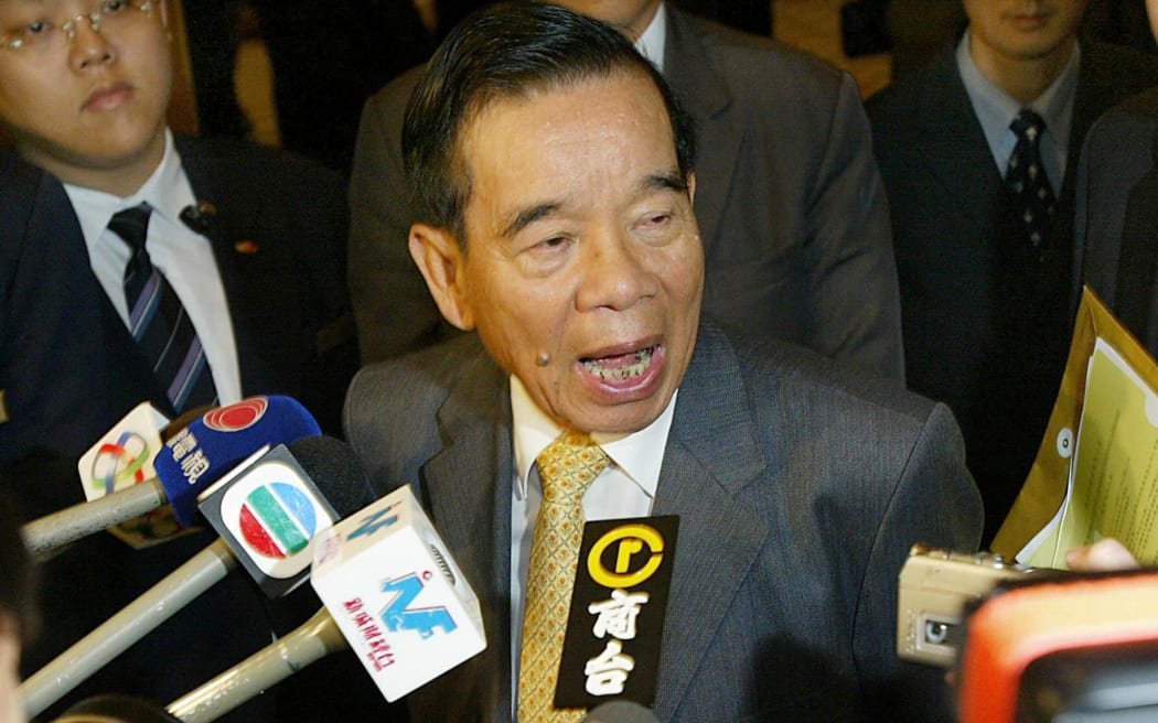 Cheng Yu-Tung, chairman of New World Developments, leaves the company's annual general meeting in Hong Kong, 07 December 2004. Cheng commented that plans to demolish an unoccupied residential development in the Kowloon district of Hong Kong would go ahead. The controversial plan to demolish 2,500 never-occupied Hong Kong flats, originally built by the government and since passed into the hands of development companies at a below-market price, has caused the outcry here in the former British territory, with taxpayers and environmentalists criticising the action as wasteful.   AFP PHOTO / MIKE CLARKE (Photo by MIKE CLARKE / AFP)
