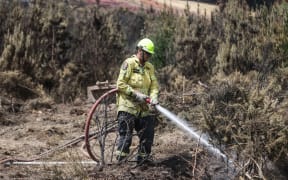 170224 CHRIS SKELTON / POOLFirefighters continue their efforts on Saturday as they work to dampen down remaining hot spots and create a buffer zone around the 24km perimeter fire ground in Christchurch's Port Hills. Pictured Stephen Robson (Peel Forest Volunteer firefighter)