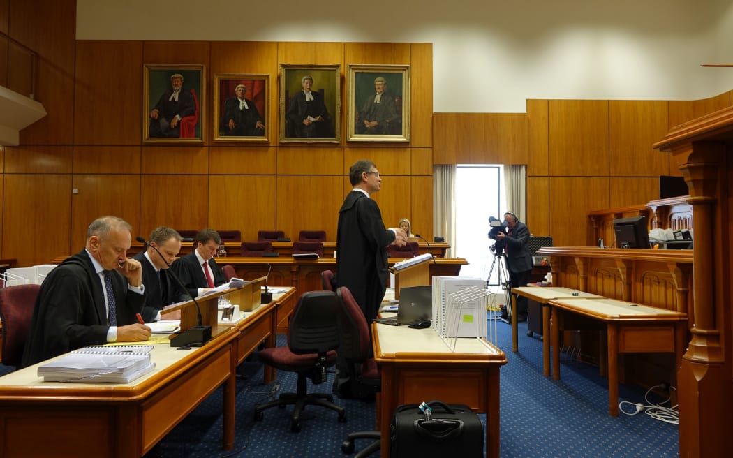 Francis Cooke QC (centre) speaks for disgruntled Southern Response customers at the High court in Christchurch.