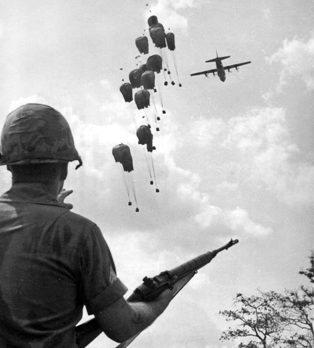 soldier with gun and plane flying
