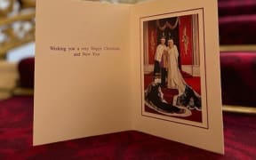 The card featuring the King and Queen shows them posing in their crowns at the Coronation earlier this year.