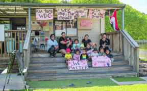 Tamariki from Te Rua Kopere Whare Kohungahunga in Tāneatua with owners and staff, Vicki Biddle-Clarke, Ngawari Teepa, Mya Strang and Moana Stensness, would like to see their an end to flooding problems at their whare. Photo Troy Baker E5051-21