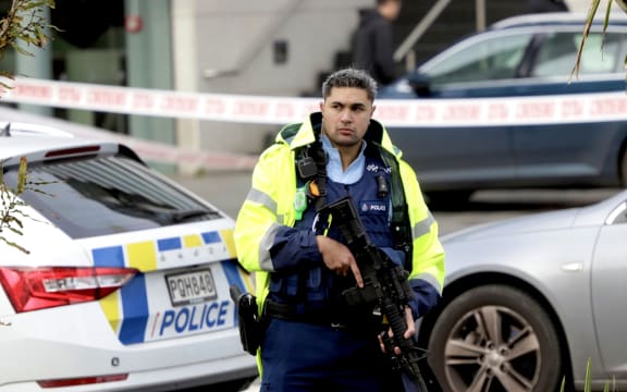 Armed police remain at the cordon of a serious shooting incident in downtown Auckland on 20 July, 2023.