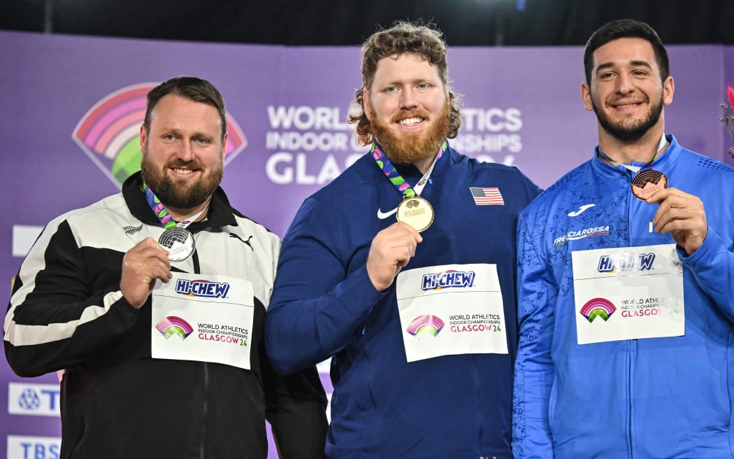 (From L) Silver medallist New Zealand's Tom Walsh, gold medallist USA's Ryan Crouser, bronze medallist Italy's Leonardo Fabbri celebrate on the podium after competing in the Men's Shot Put final during the Indoor World Athletics Championships in Glasgow, Scotland, on March 2, 2024. (Photo by Ben Stansall / AFP)