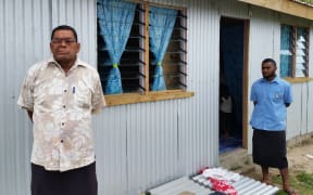 The Turaga ni Koro of Namuiamada village Usaia Rawaidranu in front of a new home.