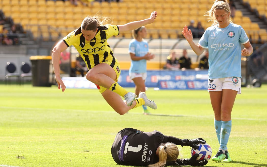 Phoenix's Ava Pritchard hurdles Melbourne City's Goal Keeper Sally James