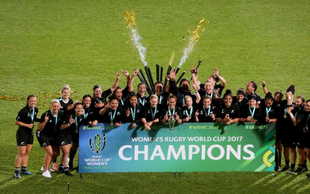 New Zealand's captain Fiao'o Faamausili holds the cup as players celebrate the fifth Black Ferns' world title.