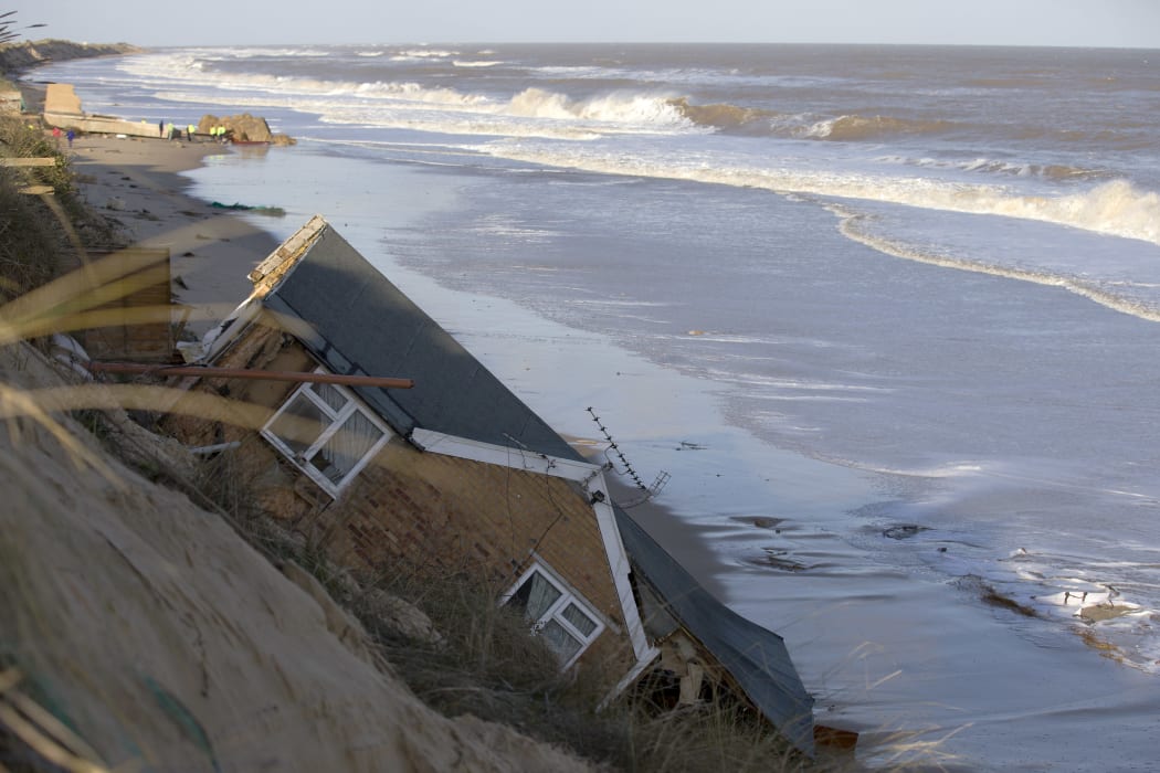 Homes collapsed into the sea during a tidal surge at Hemsby, in the east of England