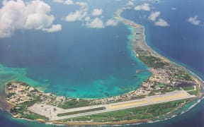 An aerial view of the southern portion of Kwajalein Atoll, with the US Army base island at Kwajalein visible in the foreground with runway, and Ebeye, home of the two missing fishermen, the third island on the right side along the eastern reef of the atoll.