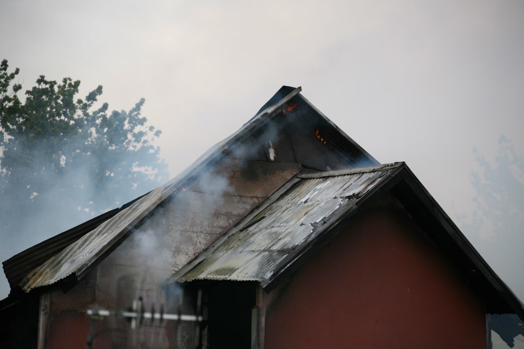 The back of St John's Presbyterian Church as fire takes hold. The church was gutted by the blaze.