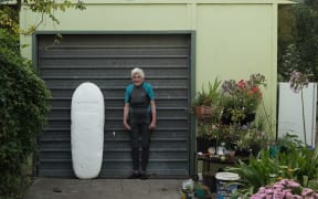 92-year-old surfer Nancy Meherne with her surfboard