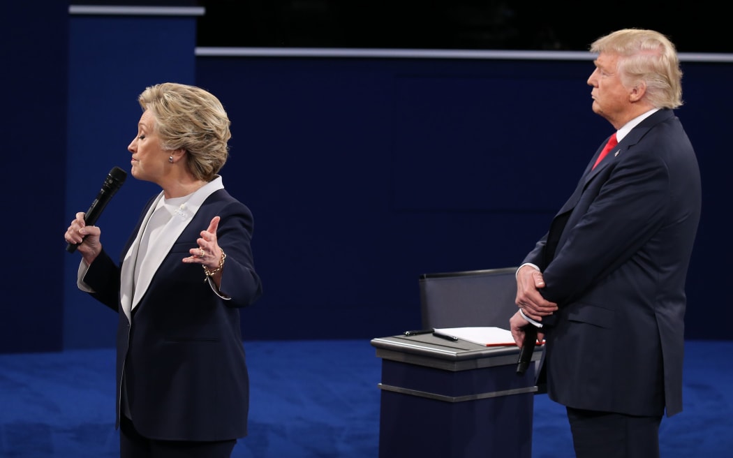 Donald Trump stands close behind Hillary Clinton at the second presidential debate 2016.