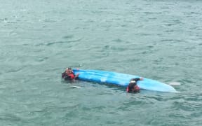The capsized kayak.