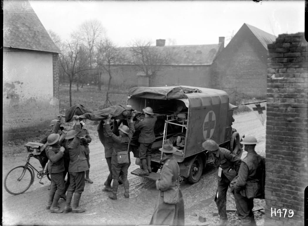 Wounded New Zealand soldiers are placed in a motorised ambulance in France.