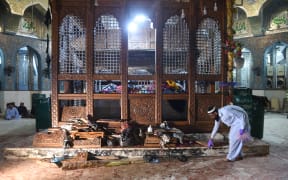 A Pakistani security official collects evidence a day after the bomb attack.