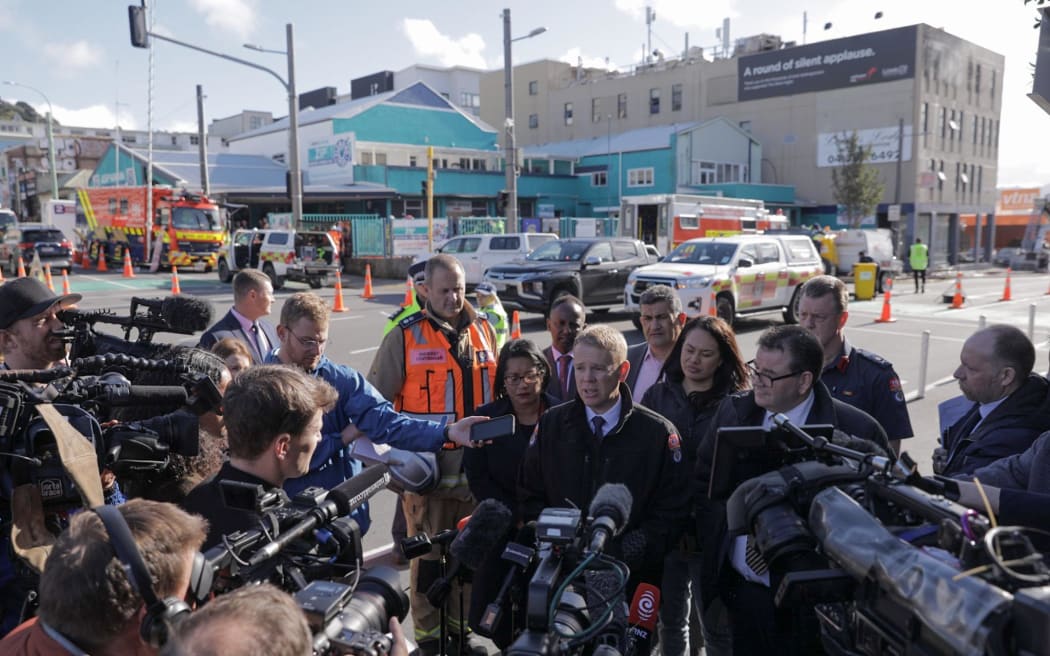 Prime Minister Chris Hipkins, Wellington Central MP and Finance Minister Grant Robertson and Wellington mayor Tory Whanau at the scene of the fire at Loafers Lodge hostel, Newtown.