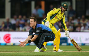Matt Henry about to complete his controversial caught and bowled of Australian batsman Mitch Marsh.