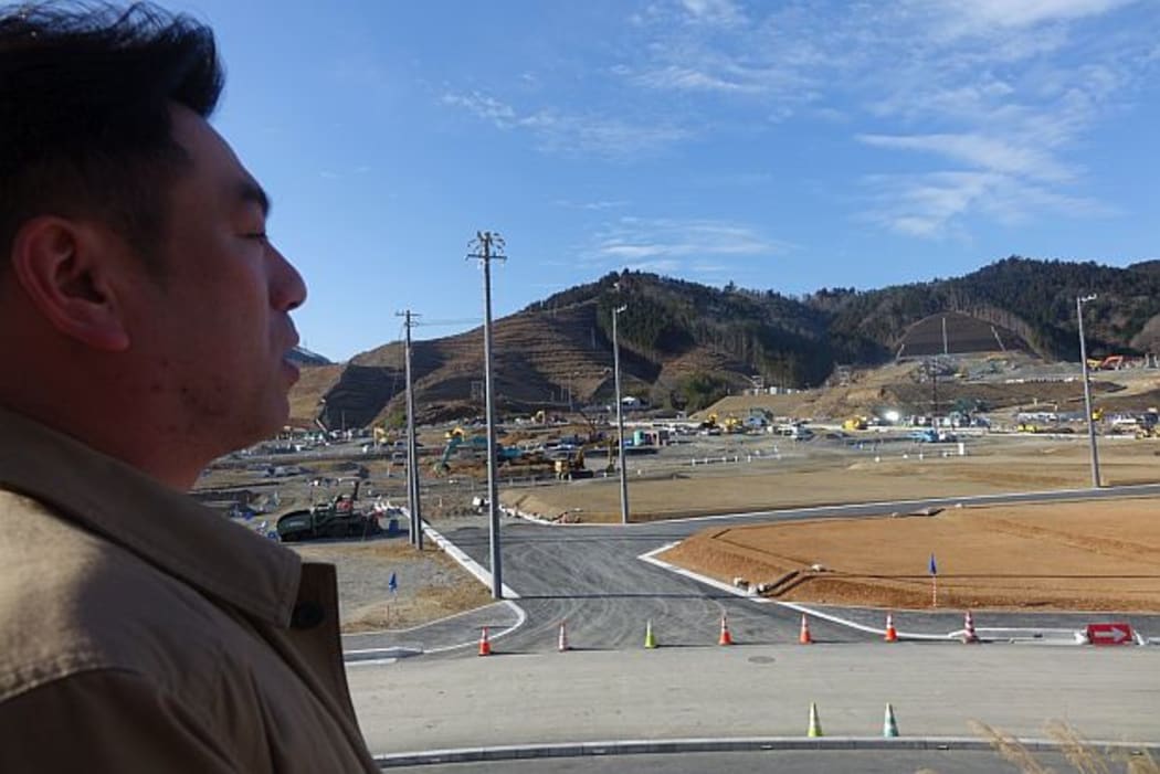 The Mayor of Onagawa, Yoshiaki Suda, surveying reconstruction work.
