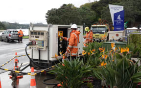 Top Energy workers installing a portable generator on Marsden Road in Paihia.