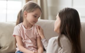 A mother talking to her daughter.