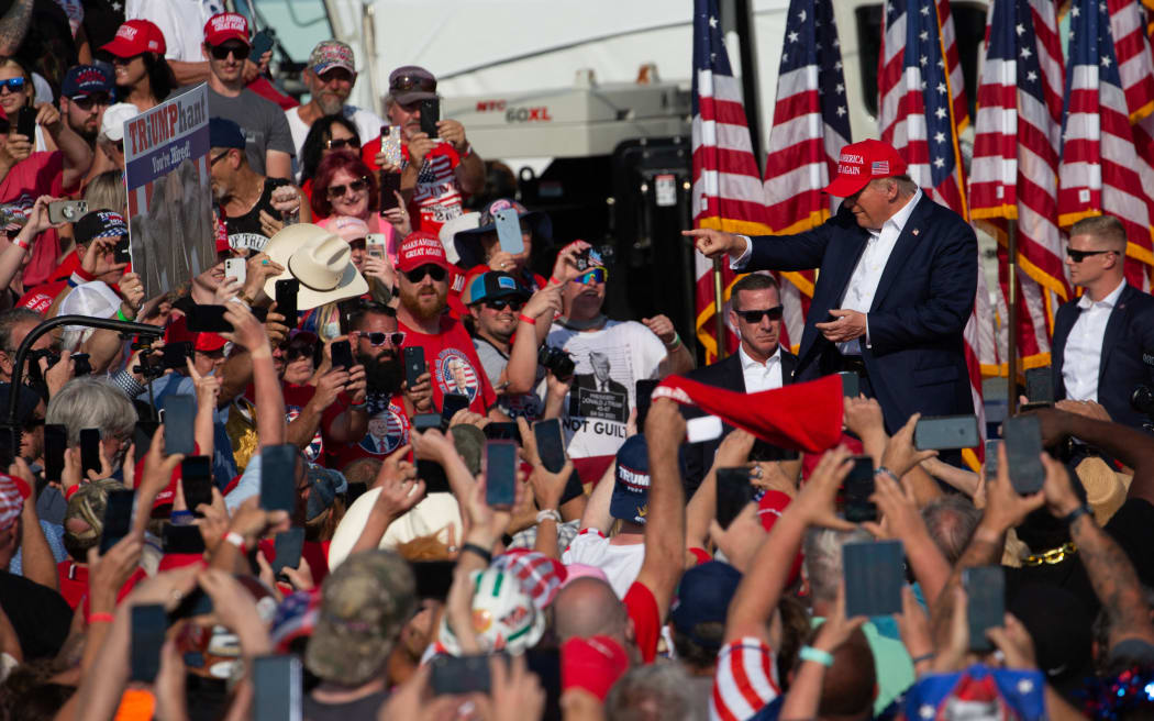 Former US President Donald Trump greets the crowd as he arrives at a campaign event at Butler Farm Show Inc. in Butler, Pennsylvania, 13 July, 2024, before shots rang out.