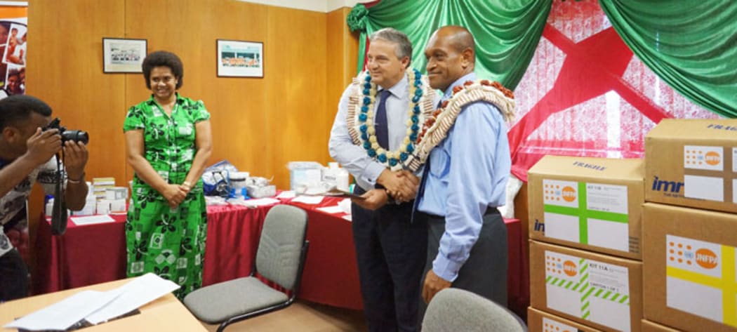 Fiji's health minister, Jone Usamate (right), and Dr Laurent Zessler of the UNPA (left).