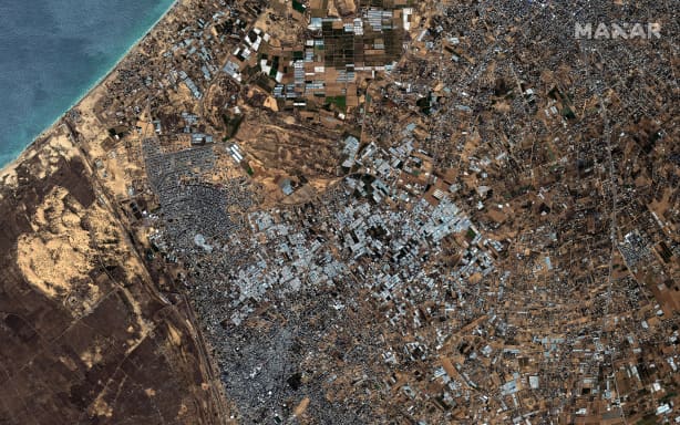 This handout satellite picture courtesy of Maxar Technologies taken on October 15, 2023 shows an overview of Rafah border crossing to Egypt (C) and South Gaza Strip (R).