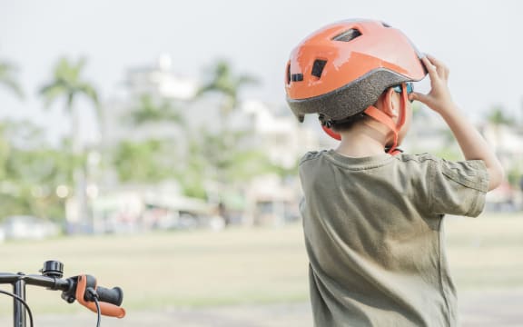 Little boy riding a bike in the park. Child on bicycle. Looking forward ahead.