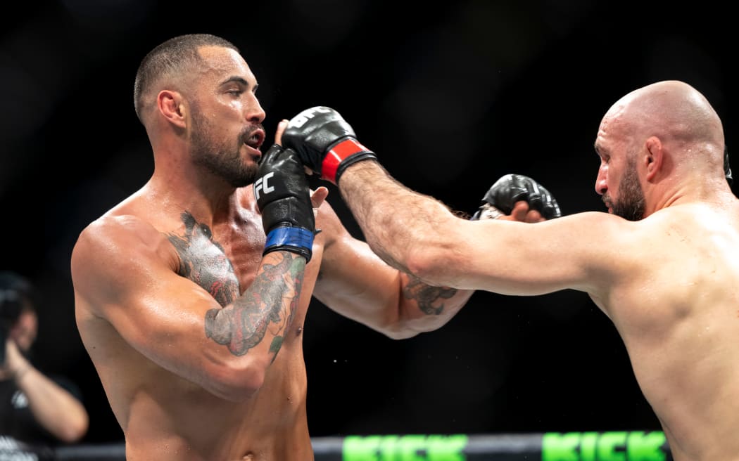 New Zealand's Carlos Ulberg (L) fighting Volkan Oezdemir of Switzerland in a UFC Fight Night event in Macau.