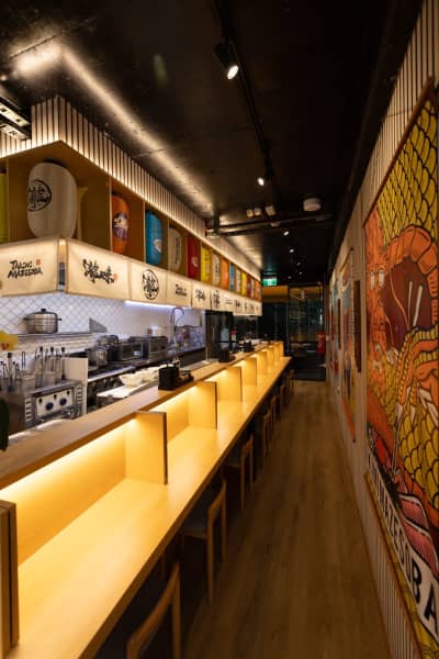 Dining booths for one welcome solo eaters at Takimi Mazesoba.