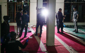 Police officials carry out an on-site investigation following a blast at a mosque inside a school in Jakarta on 7 November, 2025.