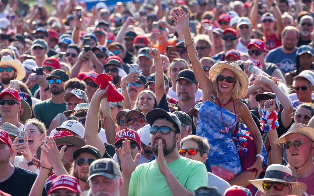 Trump supporters cheers as former US President and Republican presidential candidate Donald Trump speaks, before shots were fired at a rally in Butler, Pennsylvania, on 13 July, 2024.