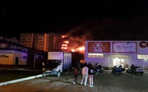 This handout picture posted on October 17, 2022 on the Telegram account of the Krasnodar region Prosecutor's Office shows an apartment building on fire after a Russian military plane crashed into a residential area of the town of Yeysk in southwestern Russia.