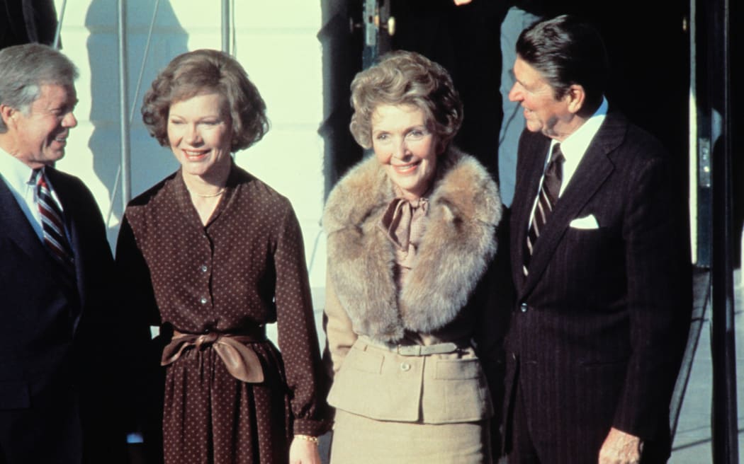 Jimmy Carter, left, Rosalynn Carter, second left, greet Ronald Reagan and his wife Nancy Reagan at the White House on 20 November 1980.