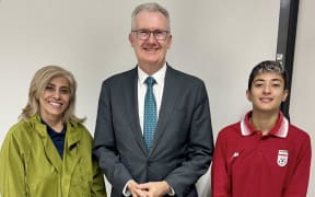 An undated photo released by Australia's Department of Home Affairs on March 11, 2026 shows Australia's Home Affairs Minister Tony Burke (C) with Iranian women's football team player Mohaddeseh Zolfi (R) and support member Zahra Soltan Meshkeh Kar (L) in Sydney, after they claimed asylum in Australia. Two more members of Iran's visiting women's football team have claimed asylum in Australia after they were branded "traitors" at home over a pre-match protest, the government said on March 11. (Photo by Handout / AUSTRALIAN DEPARTMENT OF HOME AFFAIRS / AFP) / ----EDITORS NOTE ----RESTRICTED TO EDITORIAL USE MANDATORY CREDIT "AFP PHOTO / DEPARTMENT OF HOME AFFAIRS" NO MARKETING NO ADVERTISING CAMPAIGNS - DISTRIBUTED AS A SERVICE TO CLIENTS
