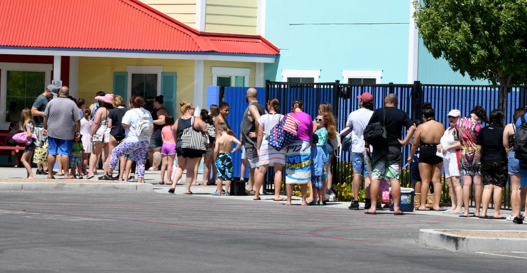 Guests line up to get into Cowabunga Bay Water Park, which was allowed to open for the first time this weekend because of the coronavirus pandemic
