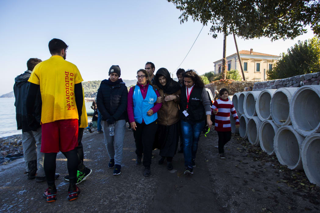 A woman from Syria receives assistance after arriving on the Greek island of Lesbos on 19 November 2015.