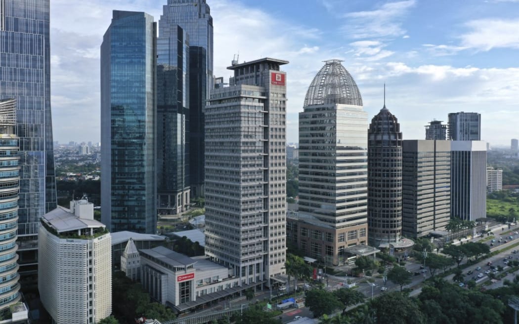 High-rise buildings are seen in Sudirman central business district in Jakarta on March 14, 2021. (Photo by ADEK BERRY / AFP)