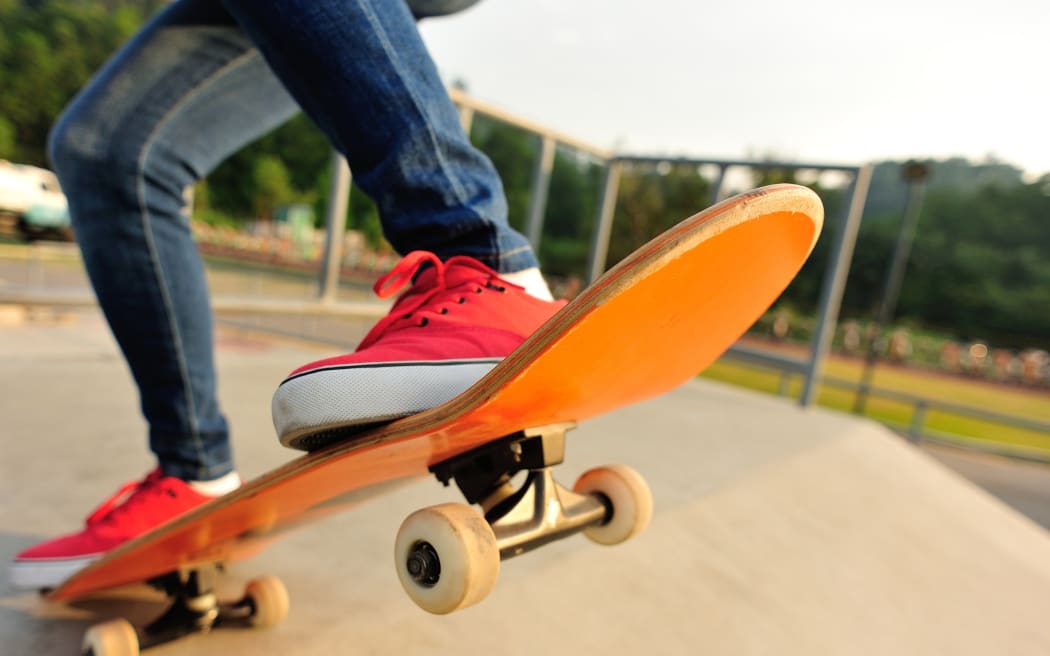 A person skateboarding at a skate park.