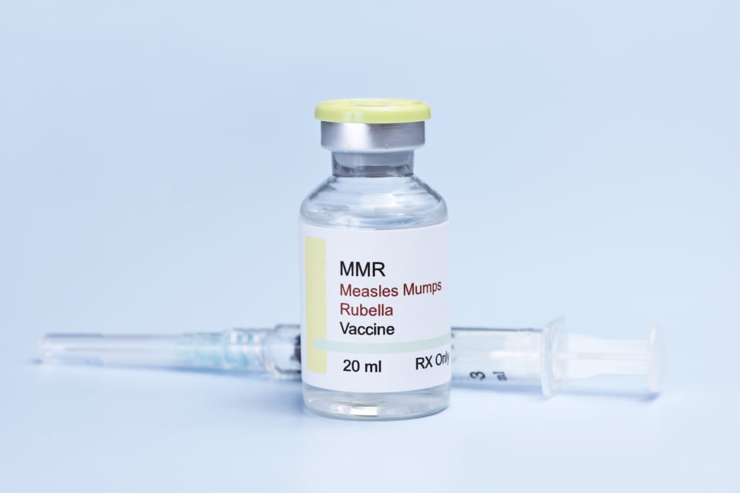 Measles, mumps, rubella, virus vaccine and syringe on blue background.