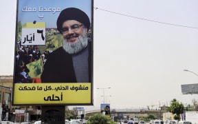 A portrait of chief of the Lebanese Hezbollah movement, Hassan Nasrallah, is fixed on the side of a road in the mainly Shiite Muslim southern suburbs of Beirut.