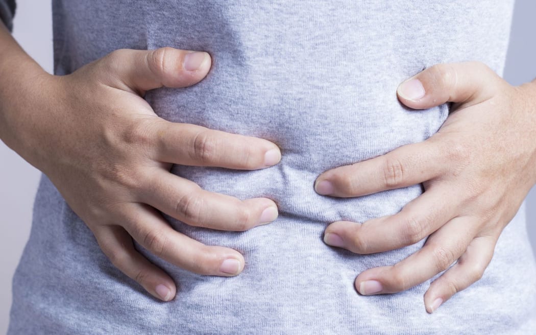 woman clutching stomach