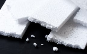 Closeup white polystyrene foam. Polystyrene foam is cushioning material in packaging, material for craft applications and other.